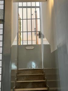 a staircase leading up to a door with a window at Dimora sicula guest house in Catania