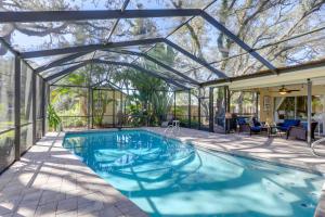 a swimming pool in a glass house with a swimming poolvisor at Prime Largo Vacation Rental with Lanai and Pool! in Largo