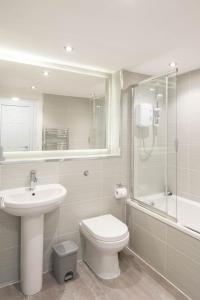 a bathroom with a sink and a toilet and a shower at Glasgow City, Hydro Apartment in Glasgow