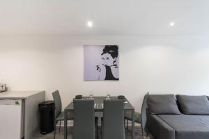 a dining room with a table and a couch at Glasgow City, Hydro Apartment in Glasgow