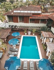 an aerial view of a resort with a swimming pool and umbrellas at Hiu Hotel in Juquei
