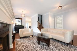 a living room with a couch and a table at Luxury Home near Wrigley, Boystown & Andersonville in Chicago