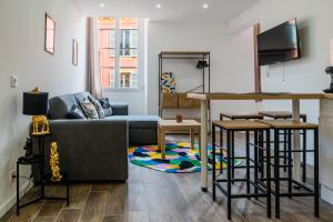 a living room with a couch and a table at Studio Nicehome Massena in Nice