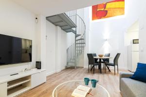 een woonkamer met een bank en een tafel bij Segismundo FreshApartments by Bossh Apartments in Málaga