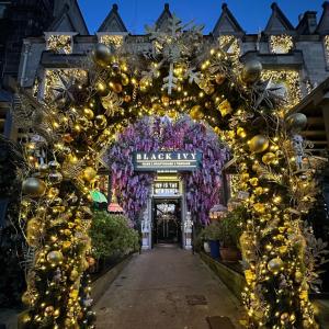 an archway in front of a store with christmas decorations at Black Ivy in Edinburgh