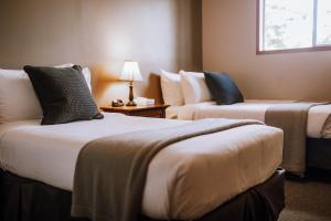 a hotel room with two beds with pillows at Page's Resort & Marina in Gabriola