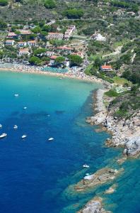 an aerial view of a beach with boats in the water at Hotel Baia Imperiale in Campo nell'Elba