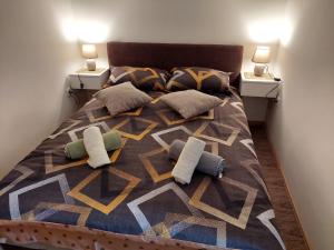a bedroom with a bed with two pillows and two lamps at DAN 9 in Sombor