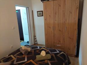 a bedroom with a bed and a wooden cabinet at DAN 9 in Sombor