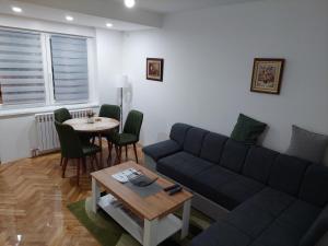a living room with a couch and a table at DAN 9 in Sombor