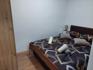 a bed with pillows on it in a bedroom at DAN 9 in Sombor
