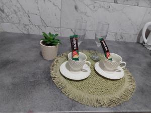 two cups of coffee on plates on a table at DAN 9 in Sombor