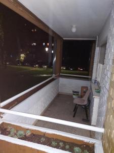 a porch with a chair and a window at night at DAN 9 in Sombor
