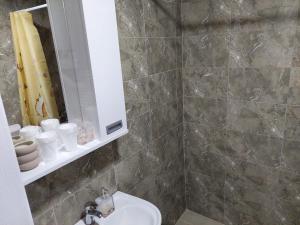a bathroom with a sink and a toilet and a mirror at DAN 9 in Sombor