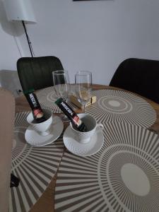 a table with two cups and wine glasses on it at DAN 9 in Sombor