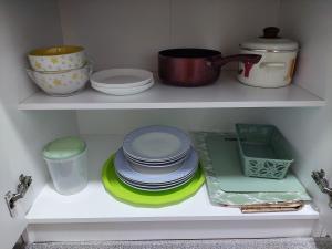 a shelf with plates and other dishes in a kitchen at DAN 9 in Sombor