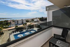 a balcony with a view of a swimming pool at Boutique Hotel IVY'Z in Novalja