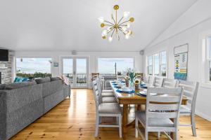 a dining room with a couch and a table at Sunrise Paradise in Camano