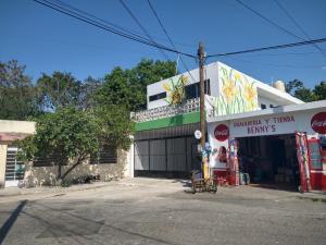a building with a garage with a sign on it at Casa Narcisa Studio Apartaments in Mérida