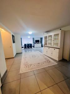 - un salon vide avec des armoires blanches et un tapis dans l'établissement Windsor Residence Grimbergen, à Grimbergen