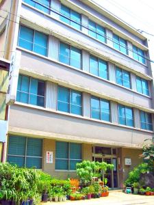 um edifício com janelas e plantas em frente em Ryokan Meiryu em Nagoia