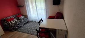 a living room with a couch and a table and chairs at Studio Cauterets centre - le Macadau in Cauterets