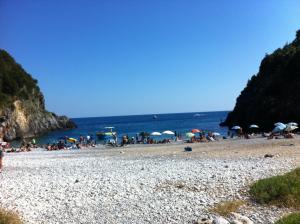 a group of people on a beach with umbrellas at Casa Velina in Castelnuovo Cilento +24 photos