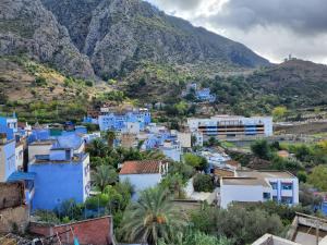 a town in the mountains with blue houses at Blue city Chefchaouen in Chefchaouene