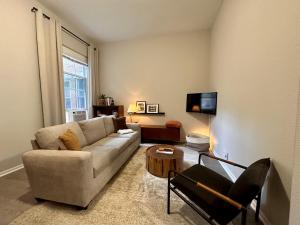 a living room with a couch and a table at Flexhome Marquette Economy 2BR MP7 - READ INFO in Milwaukee
