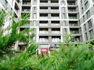 an apartment building with trees in front of it at CloudView Studio - Aviatiei, Private Underground Parking in Bucharest