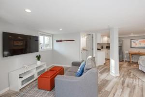 a living room with a couch and a table at Coastal Zen Cottage - Walk To Beach in Half Moon Bay