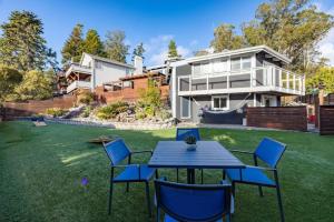 a house with a yard with a table and chairs at Coastal Zen Cottage - Walk To Beach in Half Moon Bay