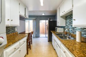 a kitchen with white cabinets and a sink at North Hollywood Home about 3 Mi to Universal Studios! in North Hollywood