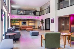 a lobby with furniture and a sign that reads wish you were here at 360 Liberdade in Sao Paulo