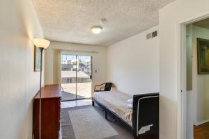 a bedroom with a bed and a sliding glass door at North Hollywood Home about 3 Mi to Universal Studios! in North Hollywood