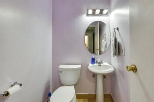 a white bathroom with a toilet and a sink at North Hollywood Home about 3 Mi to Universal Studios! in North Hollywood