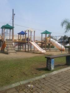 a park with a playground with a slide at Casa Neumann in Penha