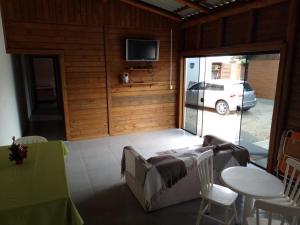a room with a table and chairs and a television at Casa Neumann in Penha +22 photos