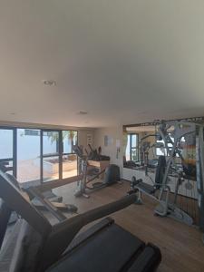 a gym with several treadmills and exercise bikes in it at Suíte acolhedora em Hotel in Natal