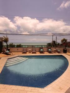 a large swimming pool on top of a building at Suíte acolhedora em Hotel in Natal