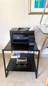 a black table with a tv and a printer at San Angel Villas in San Antonio