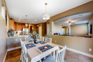 a kitchen and dining room with a table and chairs at Desert Sanctuary in Litchfield Park