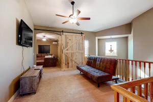 a living room with a couch and a sliding door at Desert Sanctuary in Litchfield Park