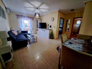 a living room with a couch and a table at Via Mar Apartments in La Mata