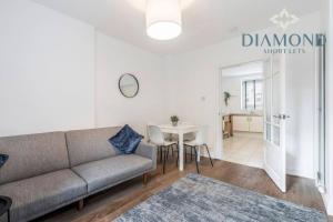 a living room with a couch and a table at FOUNDRY - 2 Bedrooms, Fully Equipped, Free Parking, WiFi, FAVOURITE for Contractors, Long Stays Welcome, Food, Bars, Shops by Diamond Short Lets in Dunfermline