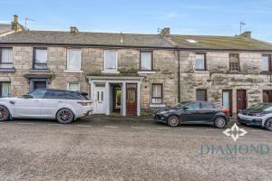 two cars parked in front of a stone house at FOUNDRY - 2 Bedrooms, Fully Equipped, Free Parking, WiFi, FAVOURITE for Contractors, Long Stays Welcome, Food, Bars, Shops by Diamond Short Lets in Dunfermline