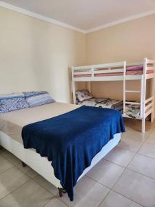 1 dormitorio con 1 cama y 2 literas en Chácara Vale do Sol, en Pinhalzinho