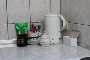 a kitchen counter with a coffee maker and other items at Apartman Bony M in Kiseljak