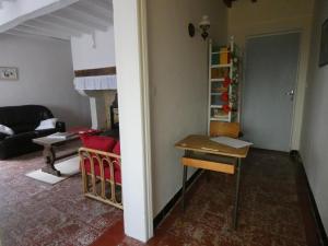 a living room with a desk and a room with a couch at Gite bonnebat in Lacrabe