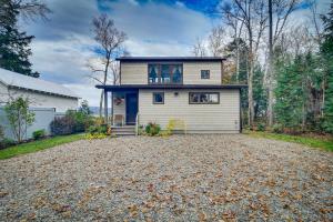 a house with a gravel driveway in front of it at Waterfront Lake Webb Cabin Rental with Dock and Views! 